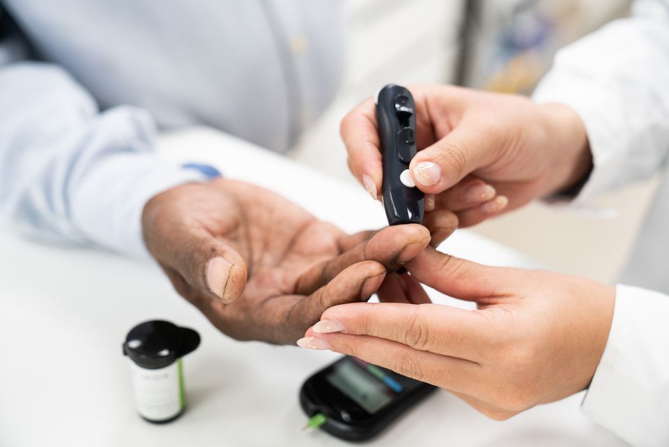 Man.checking.his.blood.sugar.getting.medical.care