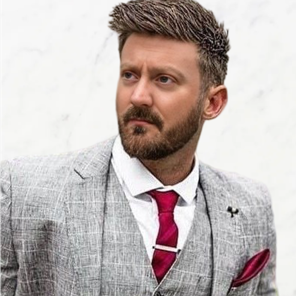 Realistic me headshot light grey suit crop bg cropped for trueshield
