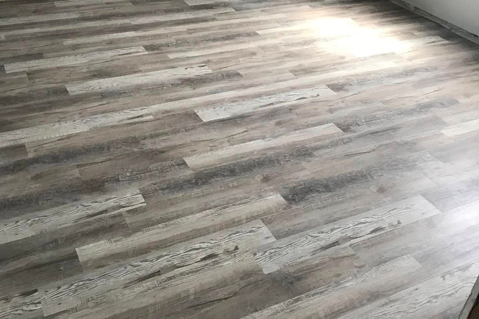 Newly installed gray wood look plank flooring