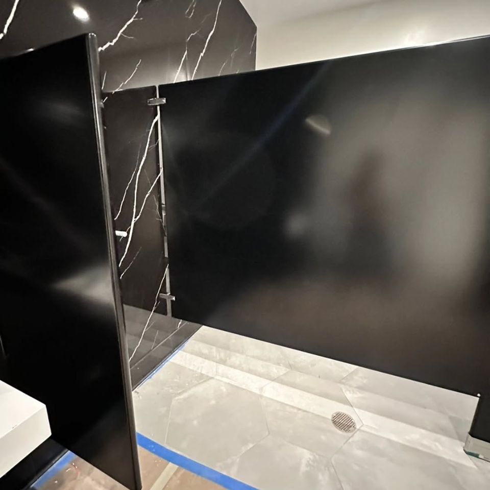 A restroom with partitions done by Pabst Leyton