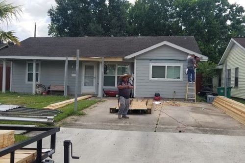 Crew preparing lumber and layout for a driveway carport in Cypress, TX