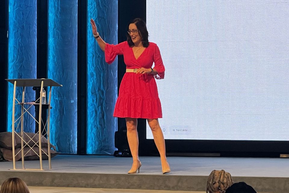 Woman standing with arm raised