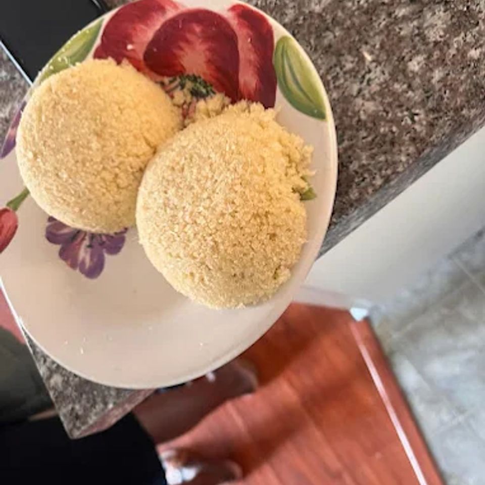 Two mounds of steamed couscous served on a floral plate