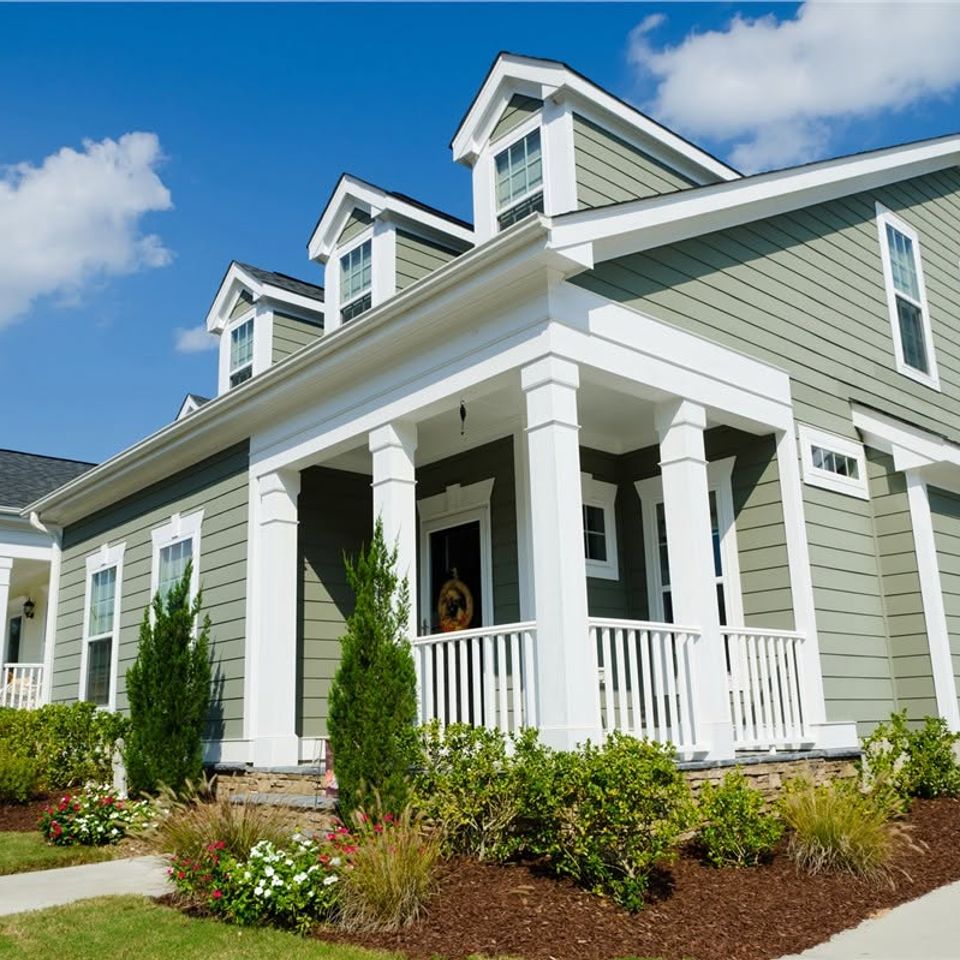 Gray craftsman home white front porch