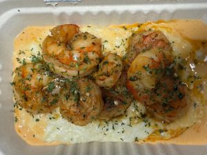 Creamy grits topped with shrimp in a spicy creole sauce
