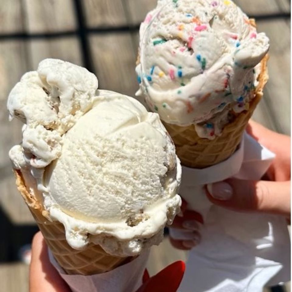 Three ice cream cones, two vanilla ice cream cones and a birthday cake ice cream cone