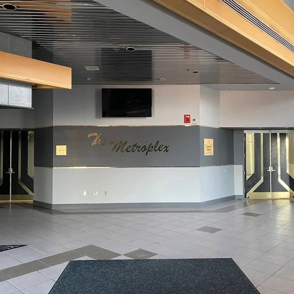 Lobby entrance of The Metroplex Expo Center in Girard with signage and event access doors
