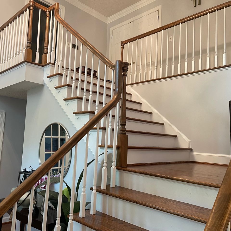Clean hardwood staircase with polished wood railings after a house cleaning service in Virginia Beach VA