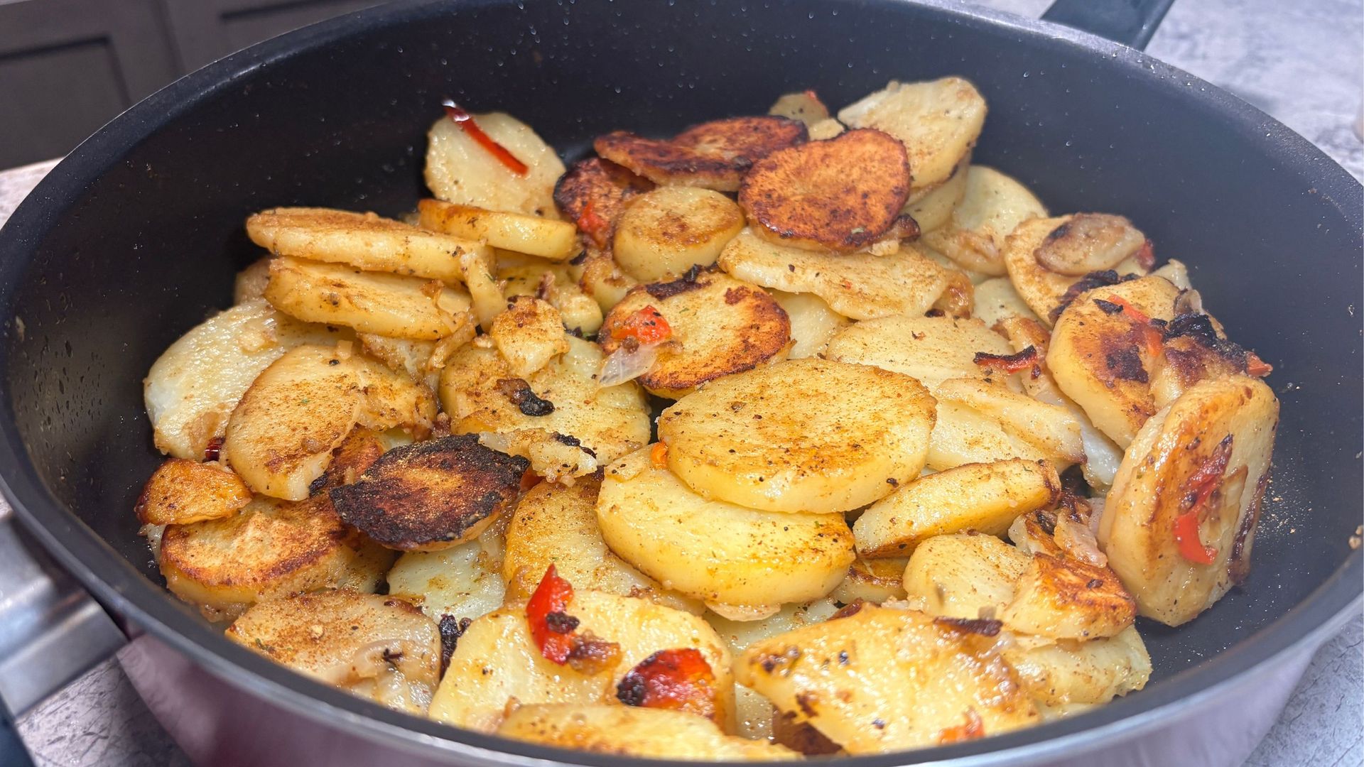 Southern fried potatoes and onions cooked in a skillet until golden and crispy