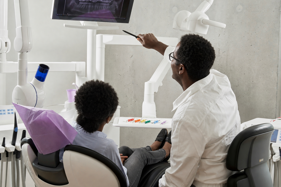 African American dentist showing xray