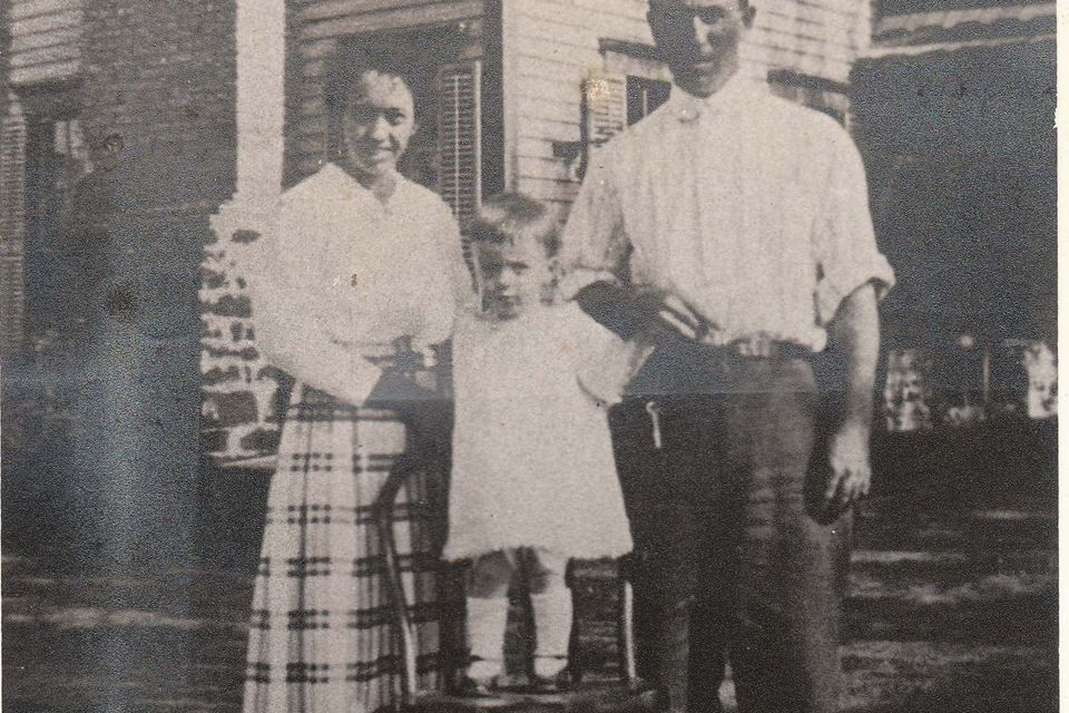 Elizabeth  olga mayes fitzgerald in front of huges home where they first lived in floresville (blakeney collection)
