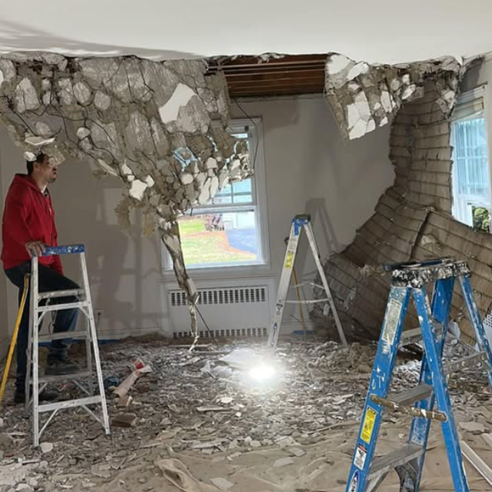 Stone fireplace demolition in progress