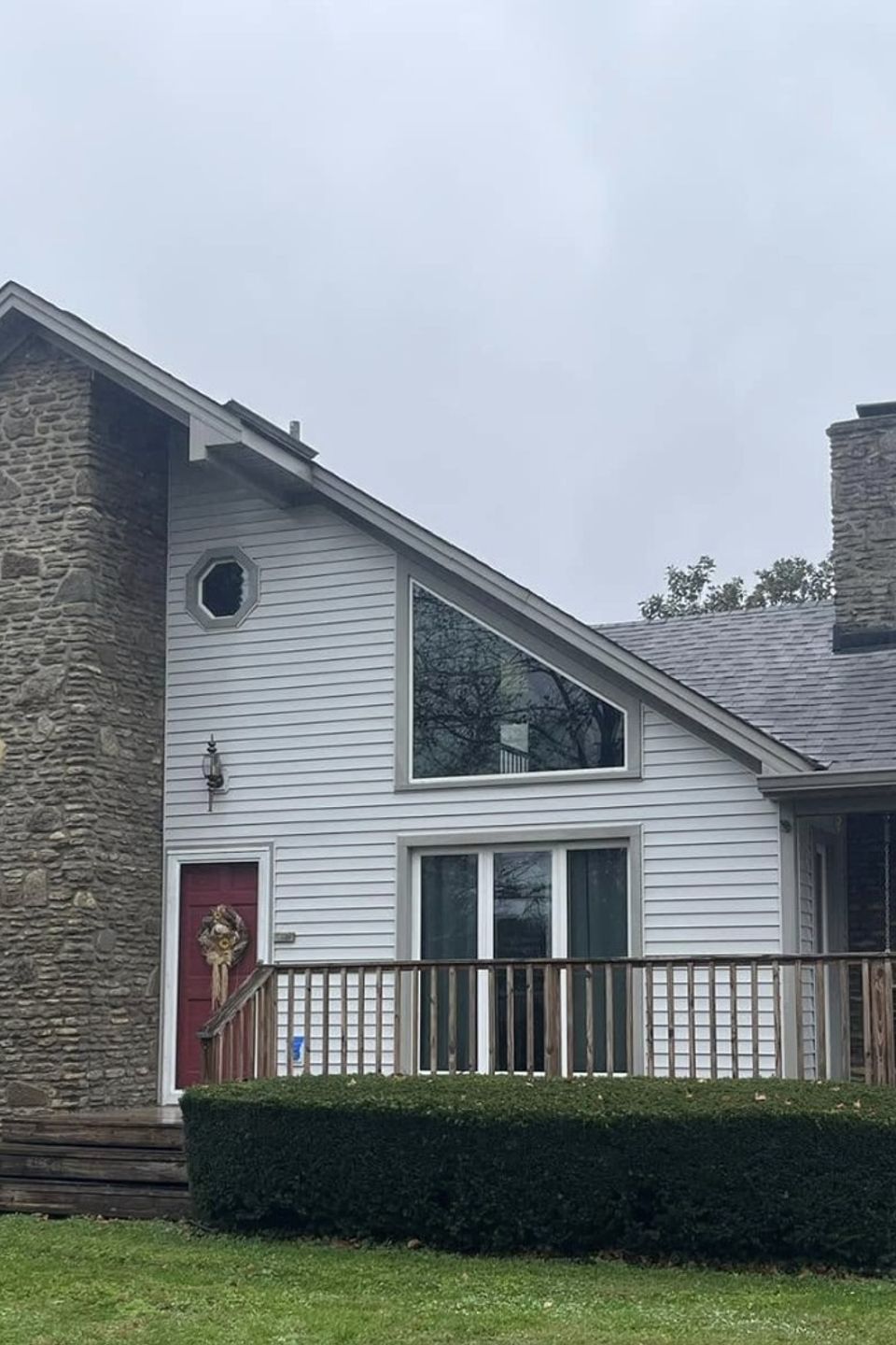 Professional pressure house cleaning on white vinyl siding in Louisville, KY by TLC Pressure Washing