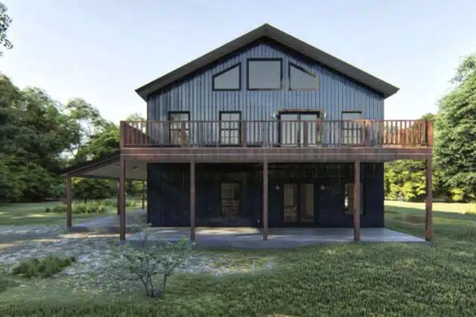 Two story barndominium with wraparound second floor balcony and covered lower patio