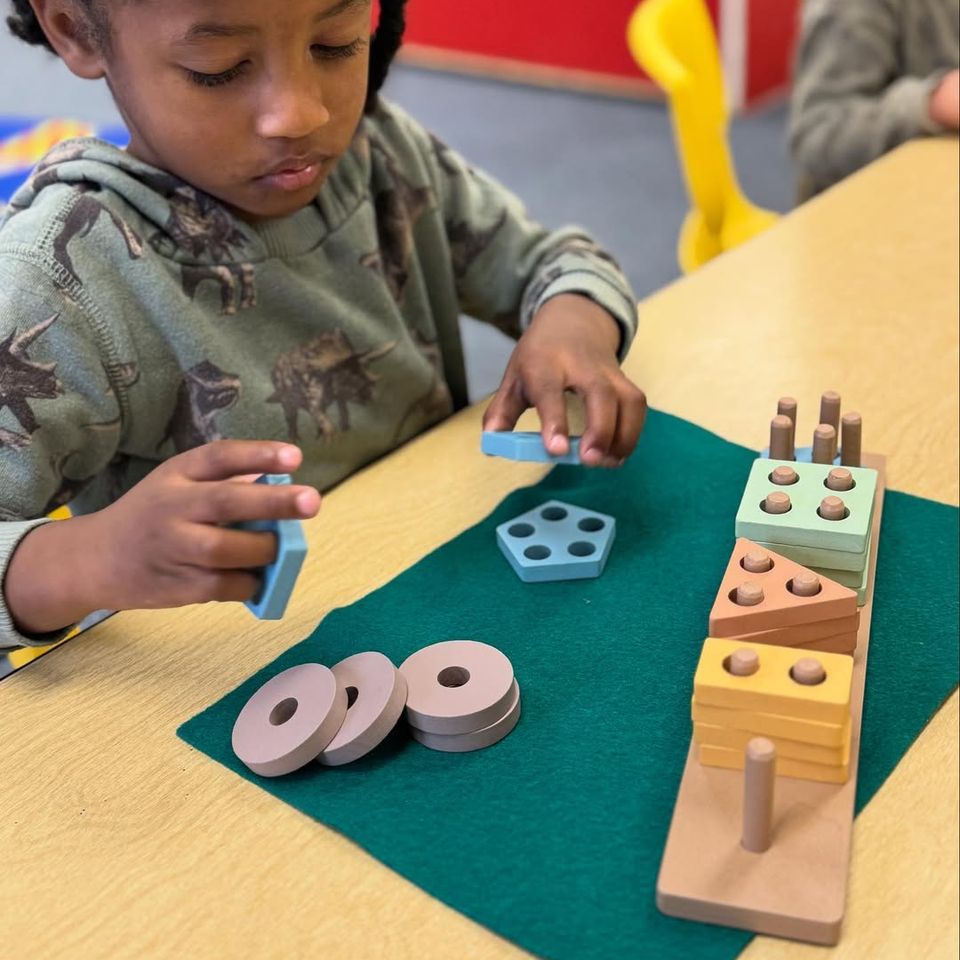 A child at Montessori Magic Key in Palmdale, CA playing with toy blocks
