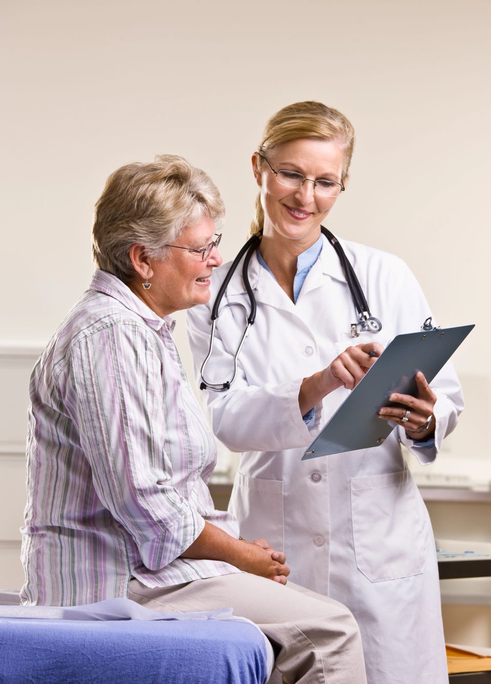 Doctor explaining medical chart to senior woman