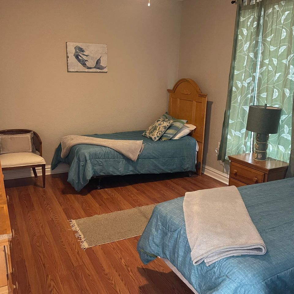 Neat bedroom with two made beds after house cleaning service in Virginia Beach VA