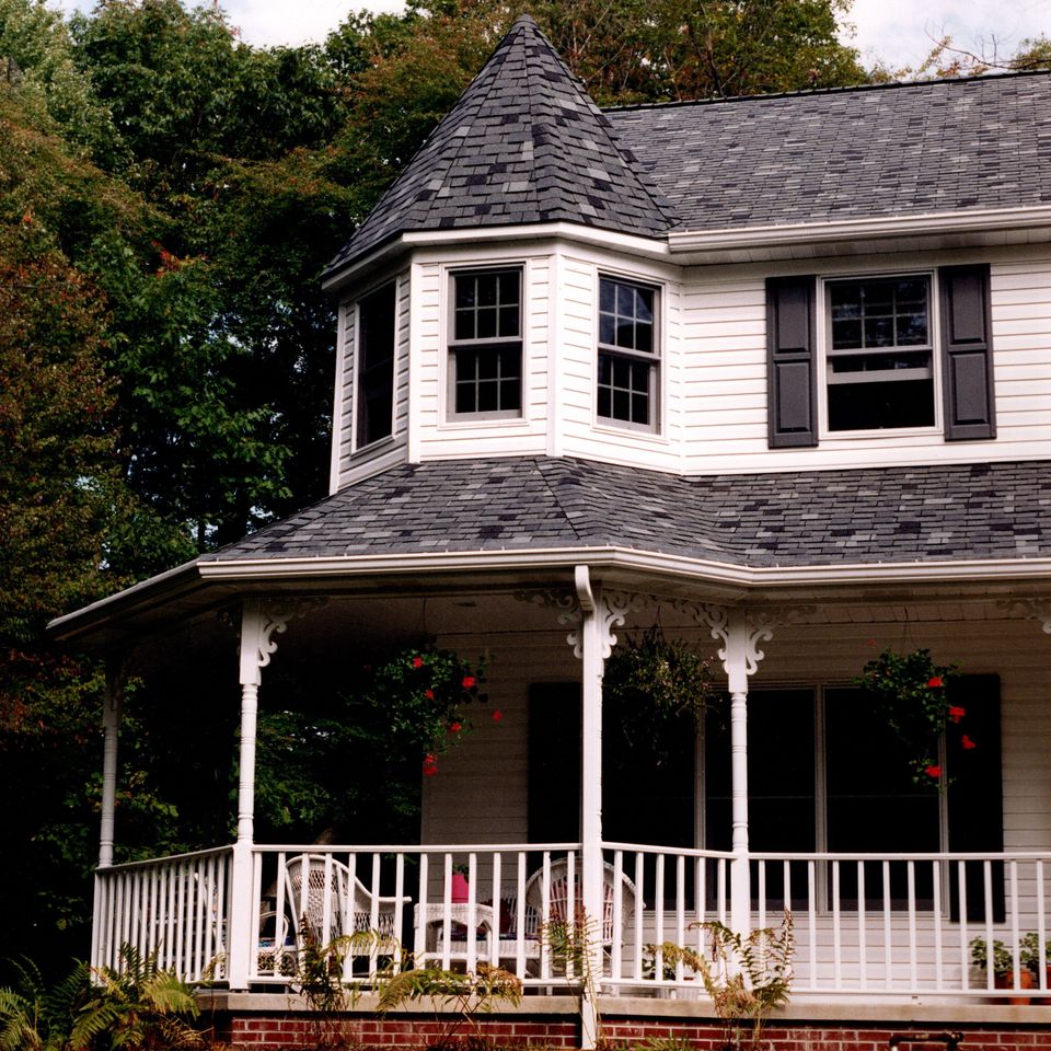 Custom home addition featuring a porch, decorative columns, and an architectural design.