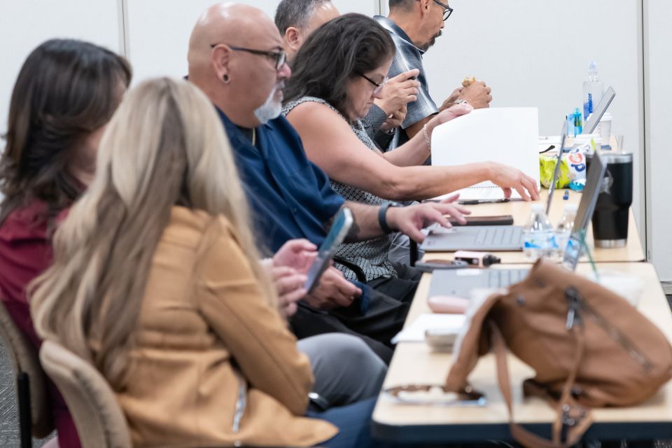 People at a table in a conference room