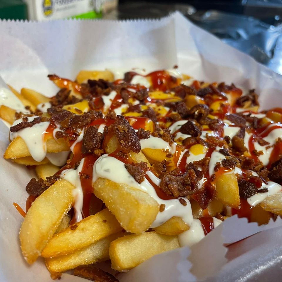 Fries topped with bacon bits and dressings from Inferno The Restaurant in Sound Beach