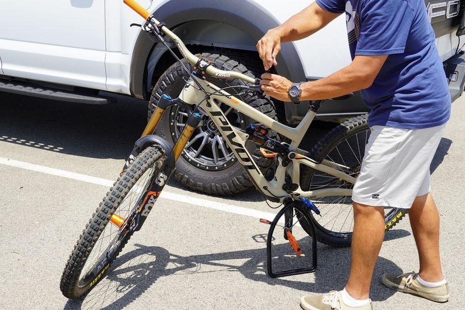 Adjusting a mountain bike held up with bike stand