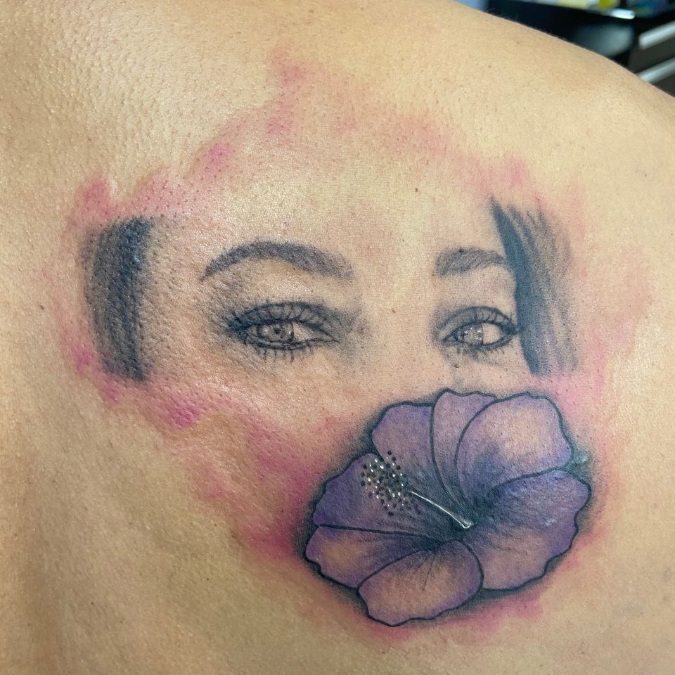 Image of one tattoo being covered over by another tattoo at the hand of tattoo artist Crazy Eagle