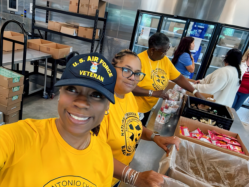 L.D. Howard and others are in a serving line at a food pantry.