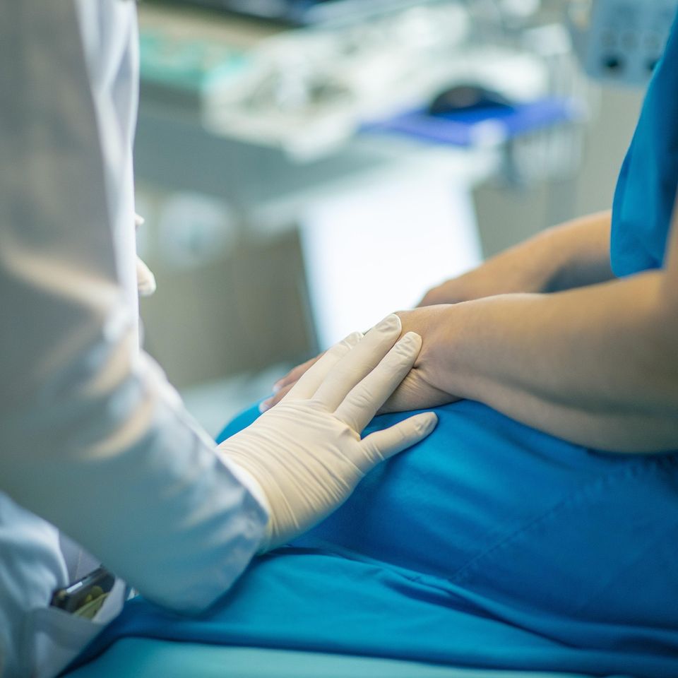 Clinician examining a patient during a medical visit