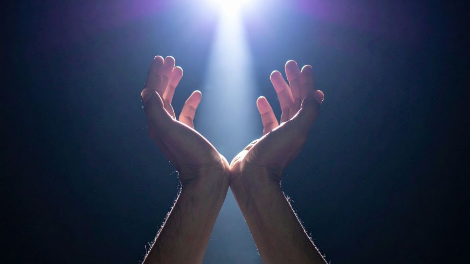 Hands open toward light (metaphor of release and renewal)