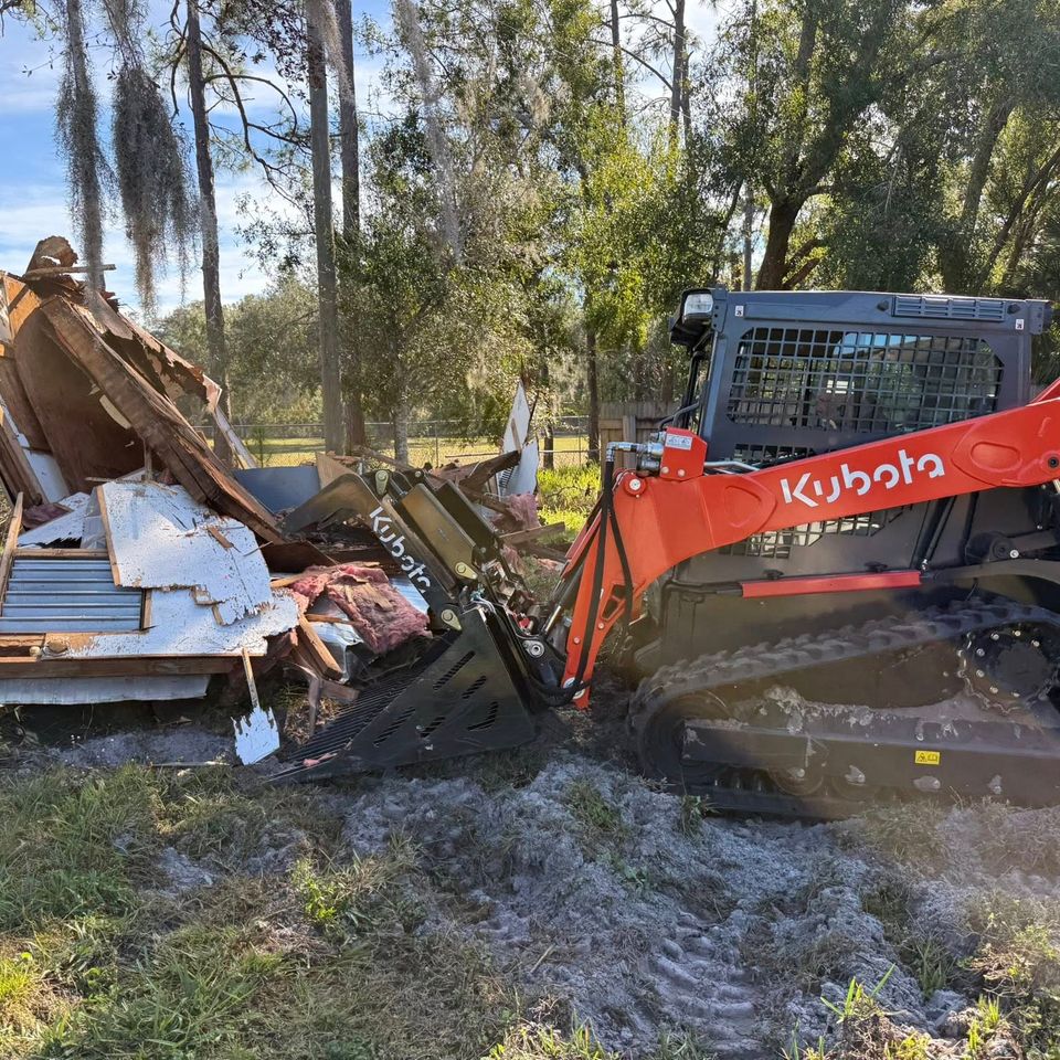 JNJ Hauling Solutions using the Kubota to remove junk