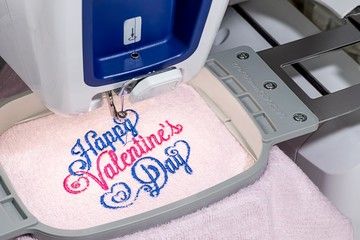 Embroidery machine sewing a design into a garment 