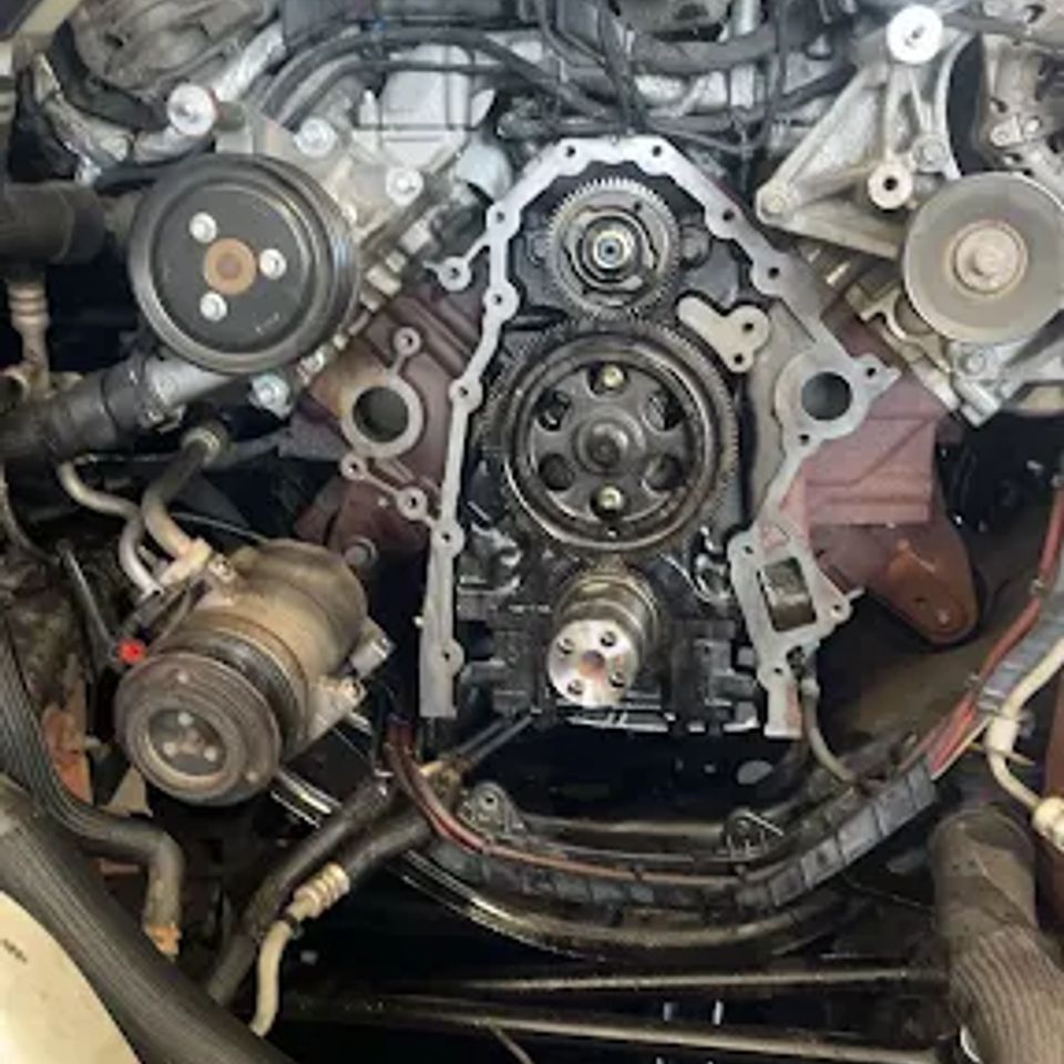 Diesel engine timing cover with exposed gears during truck engine repair in Arab Alabama