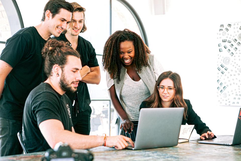Group of people around laptop