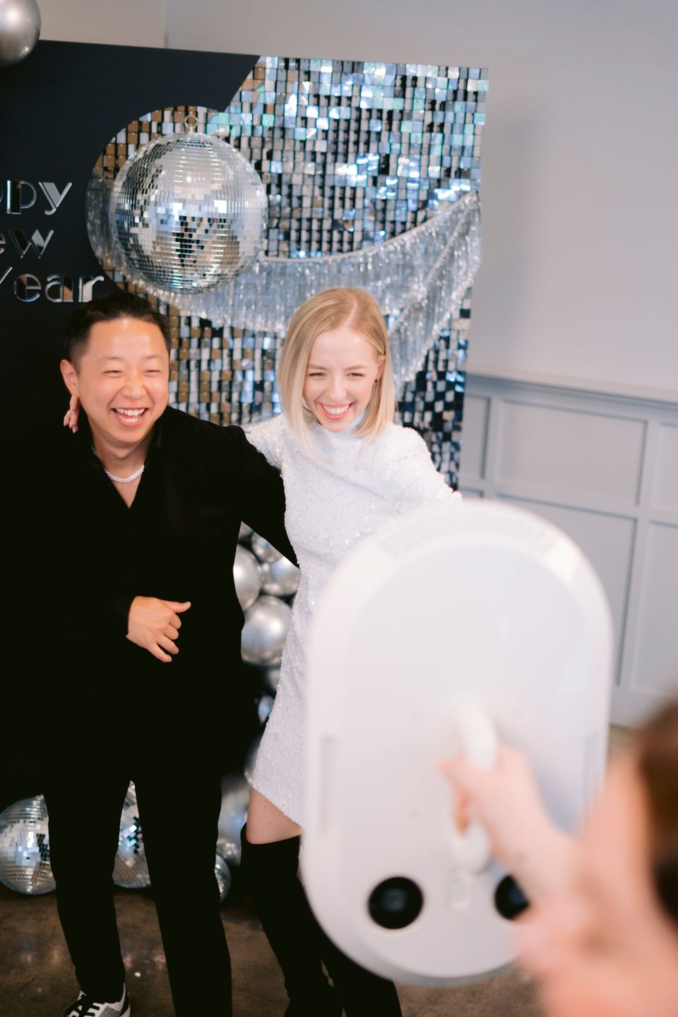 Two guests enjoying a photo booth experience at an event.
