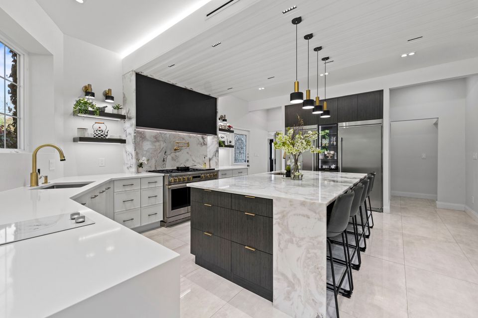 Custom-built white and navy blue kitchen featuring gold cabinet handles in Rockland County, NY.