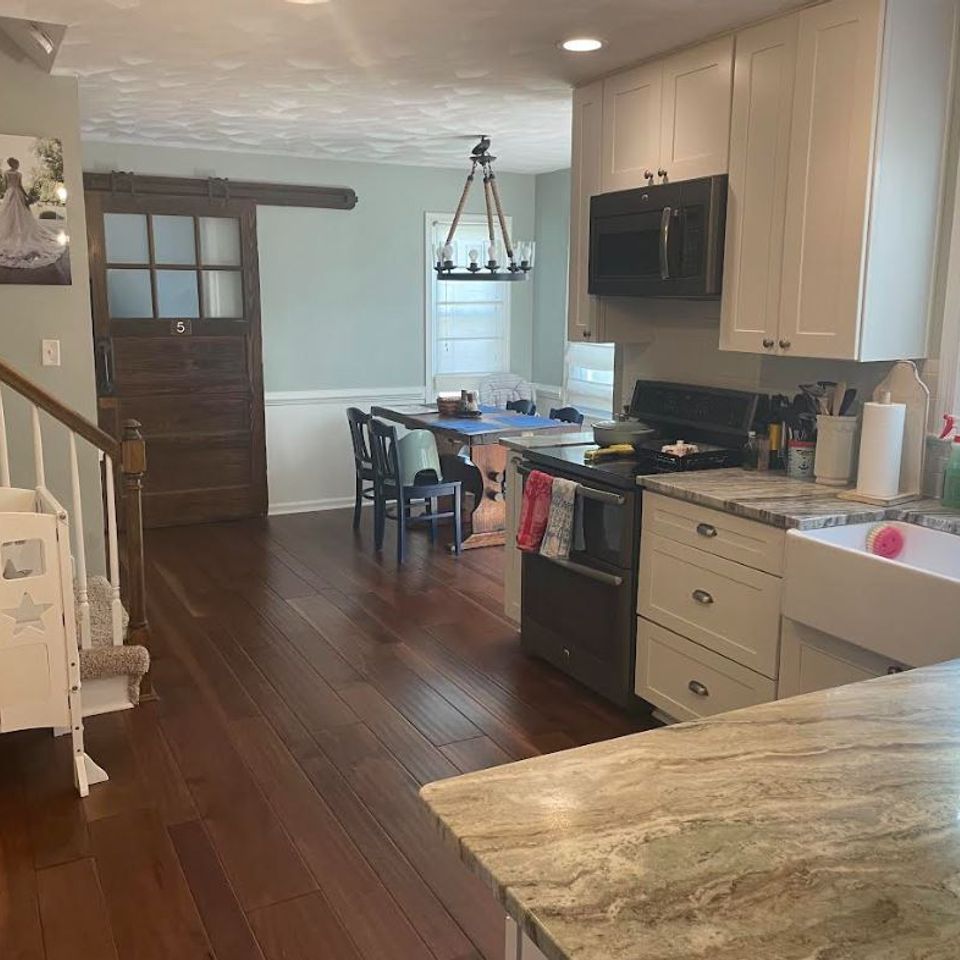 Freshly cleaned open kitchen with hardwood floors and tidy countertops after a house cleaning service in Virginia Beach VA