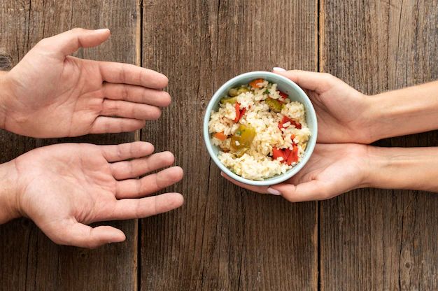 Hand giving bowl food needy person 23 2148733817