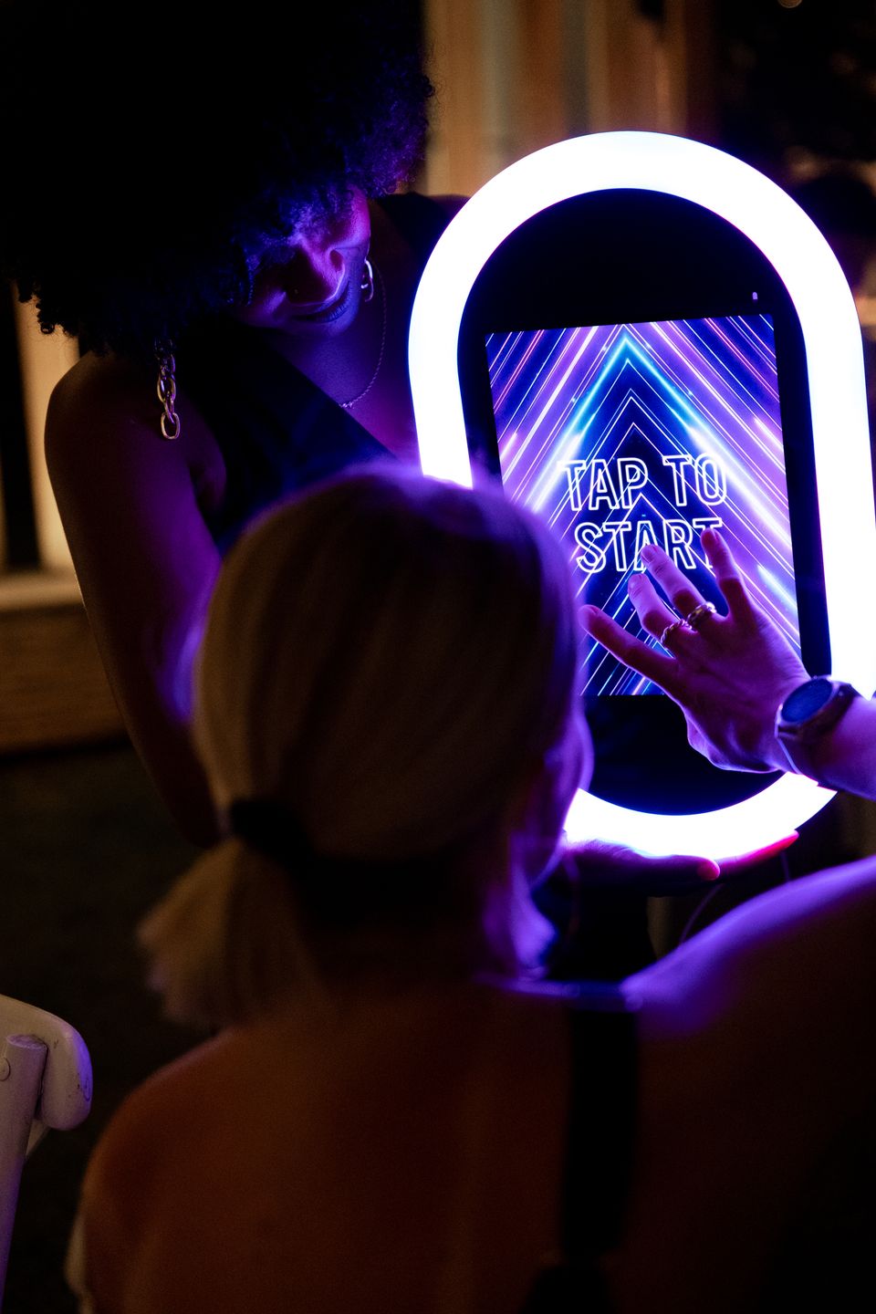 Guest tapping the screen of a modern photo booth.