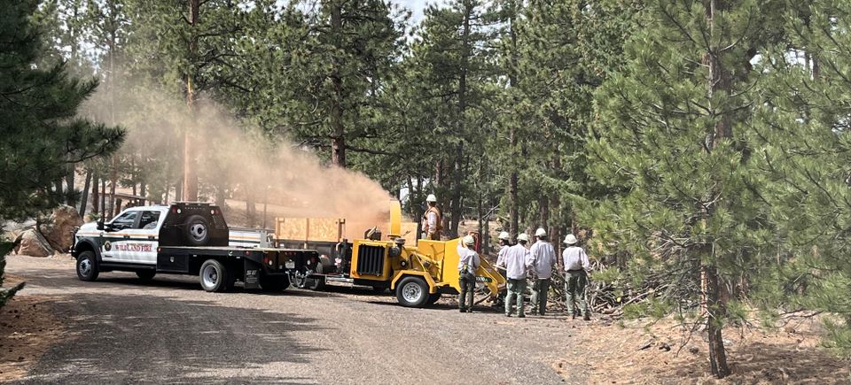 Jeffco teams putting slash piles into chipper
