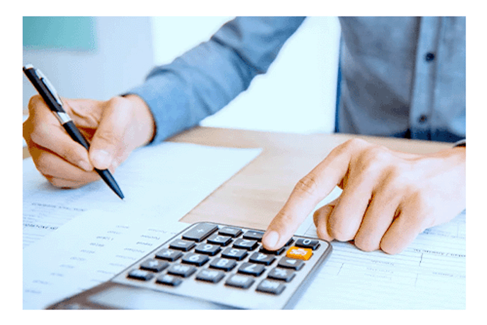 Person doing accounting with calculator