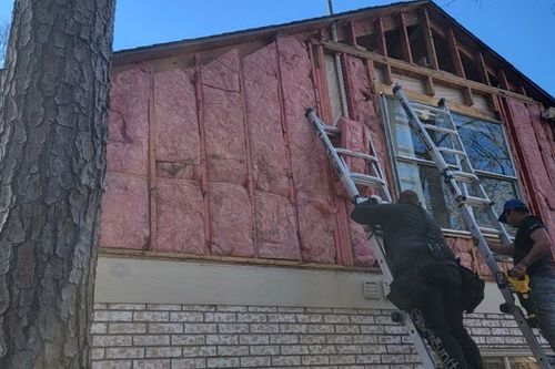 Crew verifies cavity insulation before re‑sheathing wall in Humble, TX