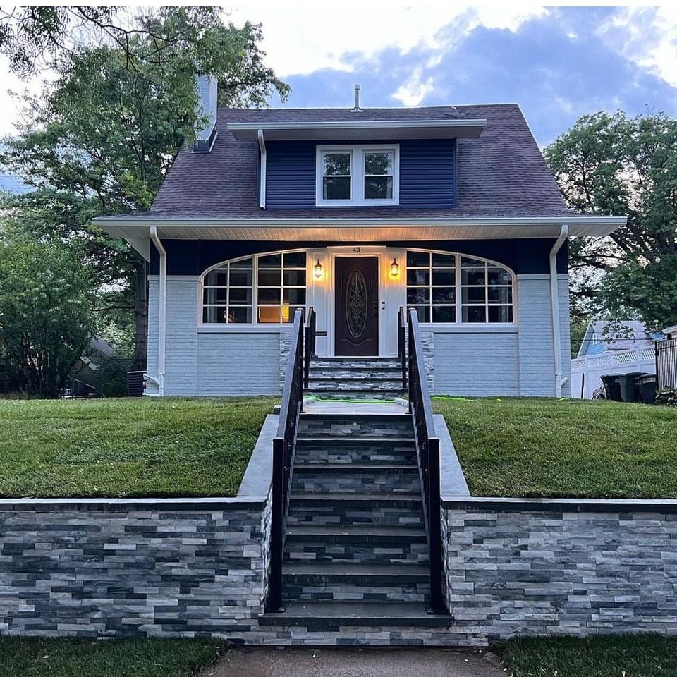 house with brick staircase and retaining wall