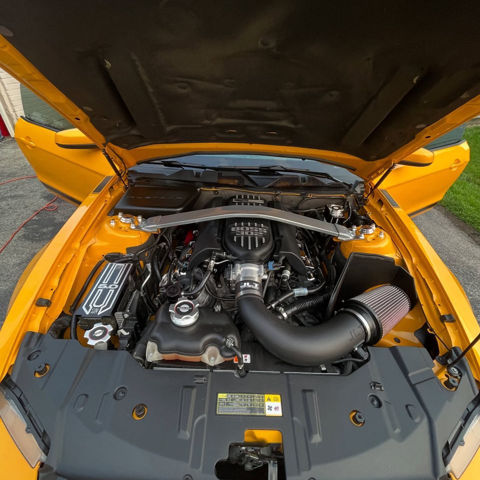 Overhead view of a fully detailed Boss 302 Mustang engine bay on a Wilmington DE driveway
