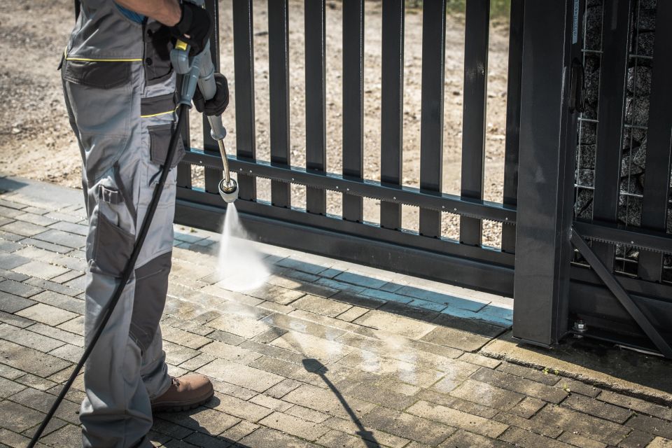 A man pressure washing his driveway