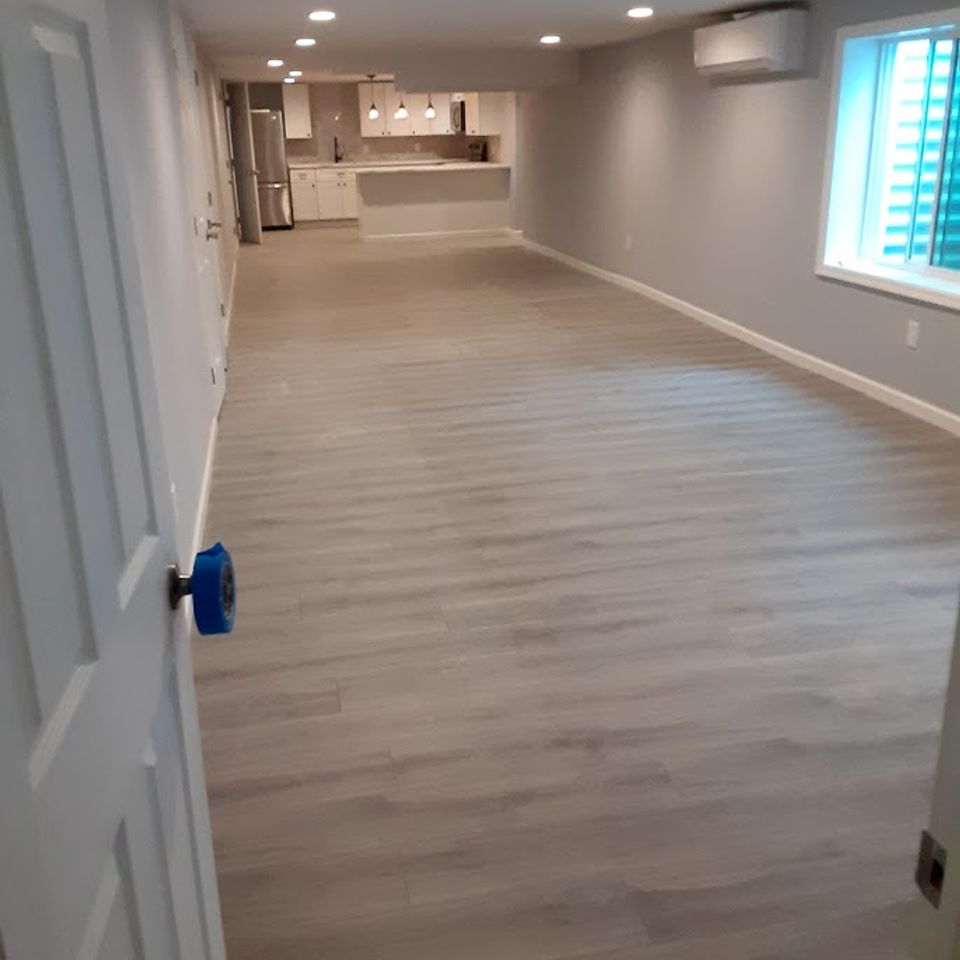 Wide shot of a fininshed basement, done by Taurus Contracting Inc., of Suffolk County NY