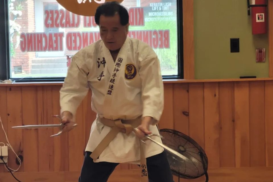 Hanshi Seiken Takamine showcasing weapon training at Takamine Karate Dojo in Miller Place