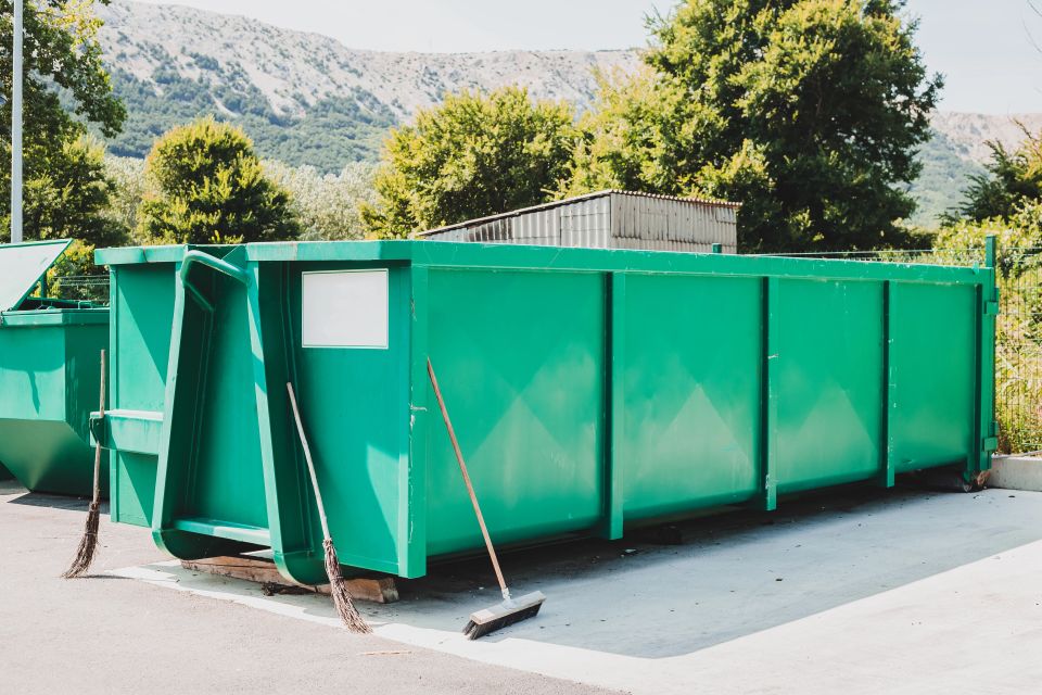 Large green garbage container at local waste sorting station