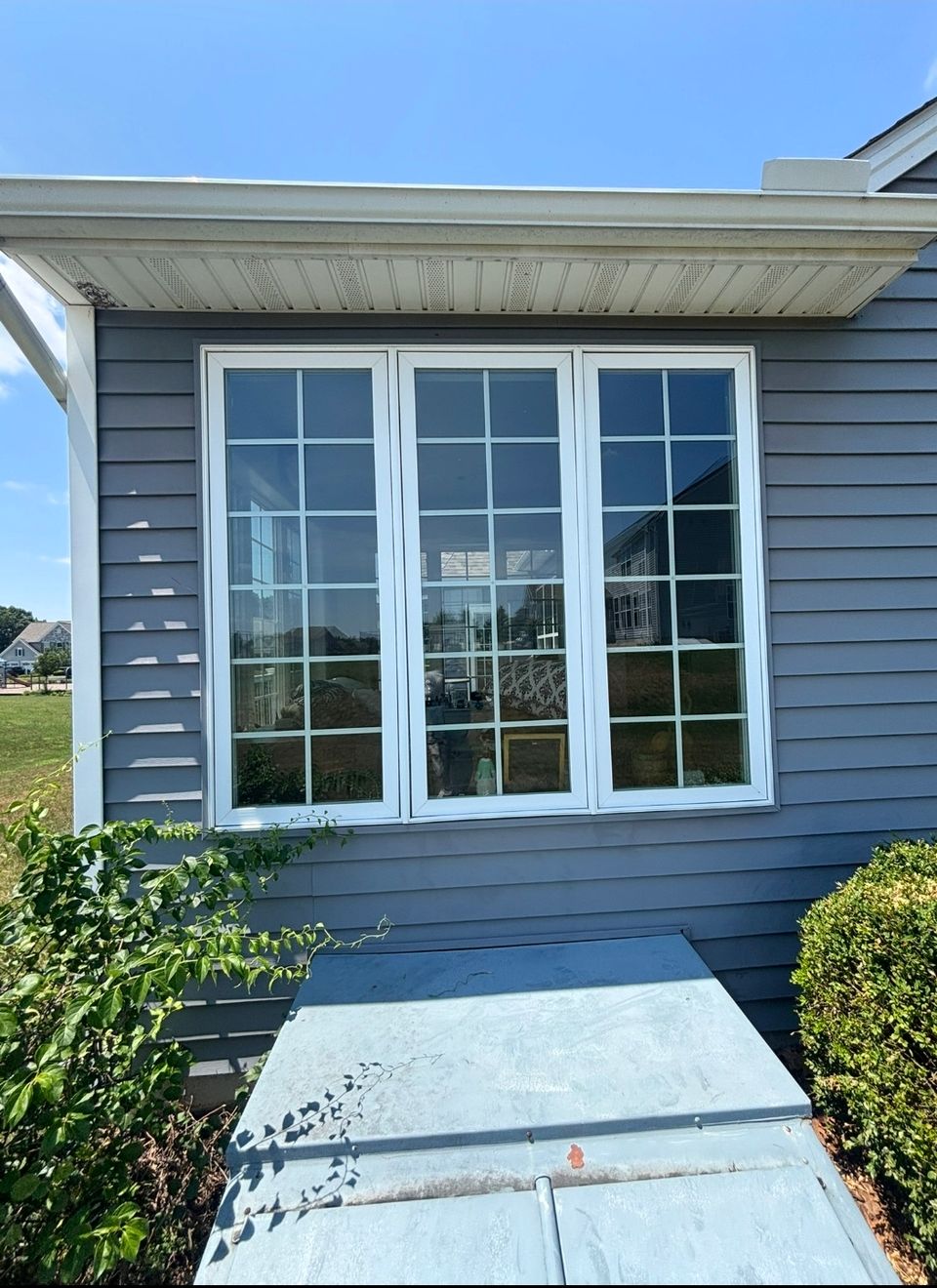 Bay window and gray siding on home exterior after window cleaning service in Harrisburg PA