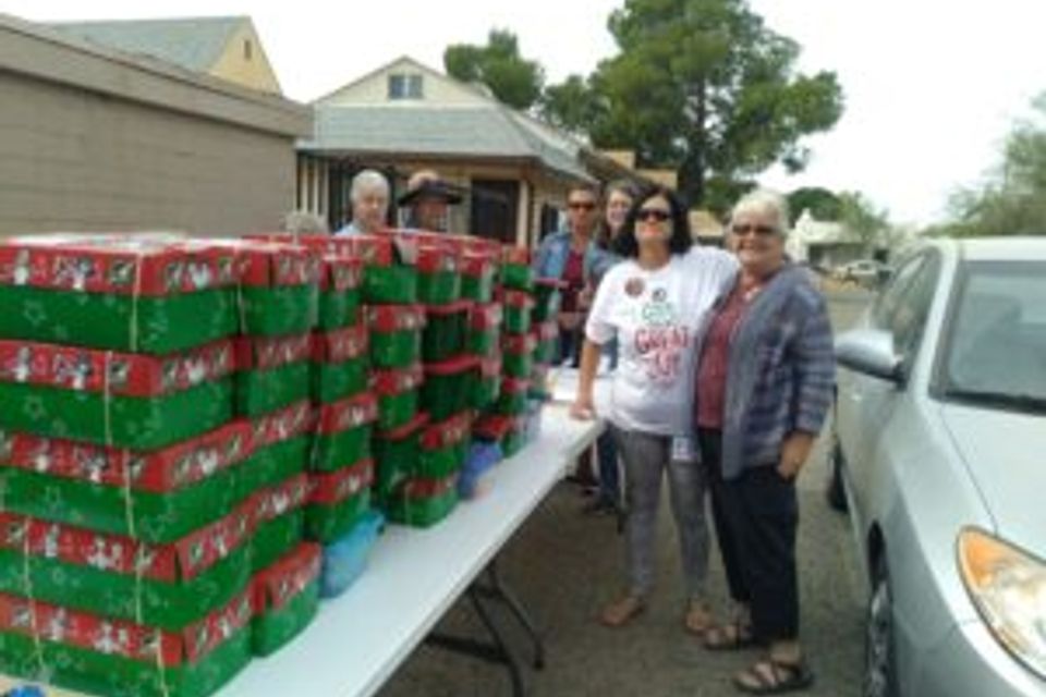 2021 operation christmas child volunteeers with shoeboxes 300x225