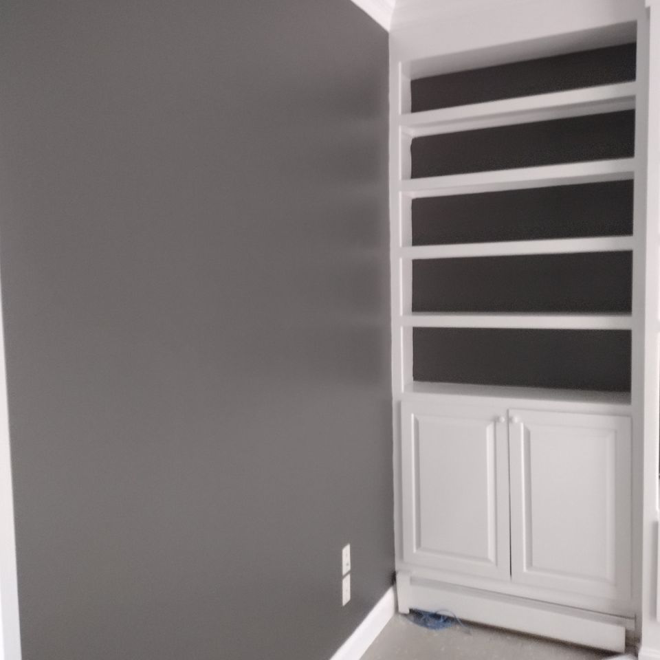 A wall painted gray, done by Taurus Contracting Inc. of Suffolk County , NY